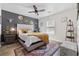 Stylish bedroom with a beautifully decorated accent wall, ceiling fan, and a unique rug at 2709 Eton St., Myrtle Beach, SC 29579