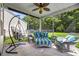 Cozy screened porch features stylish seating and hanging chair overlooking the backyard at 2709 Eton St., Myrtle Beach, SC 29579