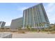 Exterior of this resort with ocean views, multiple balconies, and palm trees at 3000 N Ocean Blvd. # 420, Myrtle Beach, SC 29577
