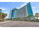 Exterior of resort with multiple floors of balconies and palm trees at 3000 N Ocean Blvd. # 420, Myrtle Beach, SC 29577