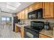 Fully equipped kitchen with wooden cabinets and stainless steel appliances at 3000 N Ocean Blvd. # 420, Myrtle Beach, SC 29577