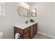 Bathroom with a gold mirror, wood vanity and white countertop providing both style and functionality at 3017 Mercer Dr. # 0, Conway, SC 29526