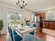 Dining room with wood floors, sliding glass door, white table, and blue chairs at 3017 Mercer Dr. # 0, Conway, SC 29526