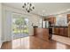 Dining room with wood floors, sliding glass door, and adjacent view of the kitchen at 3017 Mercer Dr. # 0, Conway, SC 29526