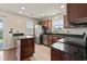 Modern kitchen with granite countertops, stainless steel appliances, and dark wood cabinets at 3017 Mercer Dr. # 0, Conway, SC 29526
