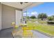 Covered porch with yellow table and chairs, offering a cozy outdoor seating area with peaceful views at 3017 Mercer Dr. # 0, Conway, SC 29526