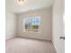 Carpeted bedroom showcasing a bright window with neighborhood views at 3308 Little Bay Dr., Conway, SC 29526