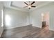 Spacious bedroom with tray ceiling, ceiling fan, and hardwood flooring at 3308 Little Bay Dr., Conway, SC 29526