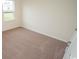 A bright bedroom features neutral carpet, light-colored walls, and a window at 3557 Ashridge Way, Conway, SC 29526