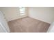 The bedroom features plush carpeting and a bright window for natural light at 3557 Ashridge Way, Conway, SC 29526