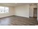 An open living room features a window to the backyard and doorway to a bathroom at 3557 Ashridge Way, Conway, SC 29526