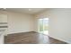 An open-plan living room features modern flooring and a sliding glass door to the backyard at 3557 Ashridge Way, Conway, SC 29526
