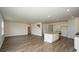 A spacious living room features modern flooring, recessed lighting, and an open kitchen layout at 3557 Ashridge Way, Conway, SC 29526