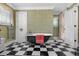 Spacious bathroom with a black clawfoot tub, black and white checkered tile, and vintage wallpaper at 3907 N Ocean Blvd., Myrtle Beach, SC 29572