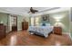 Comfortable bedroom with hardwood floors, tray ceilings, soft green walls, and nautical décor at 3907 N Ocean Blvd., Myrtle Beach, SC 29572