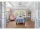 Bright bedroom boasts a tray ceiling, wood floors, and serene views from the window at 3907 N Ocean Blvd., Myrtle Beach, SC 29572