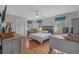 Cozy bedroom with hardwood floors, ceiling fan, and natural light from the windows at 3907 N Ocean Blvd., Myrtle Beach, SC 29572