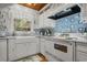 Close up of the charming kitchen with white cabinets and farmhouse style sink at 3907 N Ocean Blvd., Myrtle Beach, SC 29572
