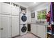 Laundry room with stacked washer and dryer, lots of storage, and a utility sink at 3907 N Ocean Blvd., Myrtle Beach, SC 29572