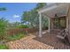 Covered brick patio with ceiling fan and white columns at 3907 N Ocean Blvd., Myrtle Beach, SC 29572