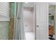 Shower area with bright white tile, white shower curtain and a conveniently placed soap dish at 3907 N Ocean Blvd., Myrtle Beach, SC 29572