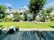 Well maintained backyard featuring green grass, mature trees, potted plants, and a privacy fence at 3978 Tybre Downs Circle # 3978, Little River, SC 29566