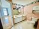 Bathroom with a double sink vanity, linoleum floors, a toilet, and a tiled shower/tub combo at 3978 Tybre Downs Circle # 3978, Little River, SC 29566