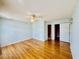 Large bedroom with hardwood floors, fan, and access to adjacent rooms at 3978 Tybre Downs Circle # 3978, Little River, SC 29566