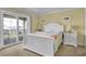 Cozy bedroom with white furniture, a comfortable bed, and access to a balcony through sliding glass doors at 421 30Th Ave. S, Sunset Beach, NC 28468
