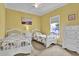 Inviting bedroom with twin beds, neutral carpet, white furniture, and a bright window with outside view at 421 30Th Ave. S, Sunset Beach, NC 28468