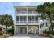 Inviting raised beach home featuring dual screened porches and charming coastal curb appeal at 421 30Th Ave. S, Sunset Beach, NC 28468