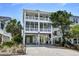 Inviting raised beach home featuring dual screened porches and charming coastal curb appeal at 421 30Th Ave. S, Sunset Beach, NC 28468