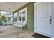 Charming front porch with seating area, perfect for enjoying the neighborhood views at 421 30Th Ave. S, Sunset Beach, NC 28468