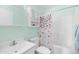 Bathroom with pastel walls, toilet, sink, butterfly shower curtain and a white cabinet at 4554 Fringetree Dr., Murrells Inlet, SC 29576