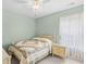 Serene bedroom with a decorative bed, nightstand, and a light-filled window at 4554 Fringetree Dr., Murrells Inlet, SC 29576