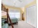 Bedroom features bunk beds with ladder, a window, and neutral carpet at 4554 Fringetree Dr., Murrells Inlet, SC 29576