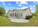 Rear view of a light grey house with a stone patio and green lawn at 4554 Fringetree Dr., Murrells Inlet, SC 29576