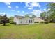 Back of house featuring windows, patio and manicured lawn at 4554 Fringetree Dr., Murrells Inlet, SC 29576