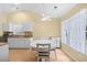 Bright kitchen and dining area with white cabinetry, granite countertops, and natural light from large windows at 4554 Fringetree Dr., Murrells Inlet, SC 29576