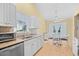 Sunlit eat-in kitchen features stainless appliances, granite counters, and a white dining set at 4554 Fringetree Dr., Murrells Inlet, SC 29576