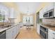 Bright kitchen with stainless appliances, granite counters, and adjacent white dining set at 4554 Fringetree Dr., Murrells Inlet, SC 29576