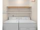 Laundry room includes full size washer and dryer with an organized shelf above at 4554 Fringetree Dr., Murrells Inlet, SC 29576