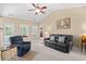Bright living room featuring vaulted ceilings, ceiling fan, and sliding glass door to the outdoor patio at 4554 Fringetree Dr., Murrells Inlet, SC 29576