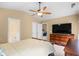 Open bedroom has ensuite bathroom and ceiling fan and tv above dresser at 4554 Fringetree Dr., Murrells Inlet, SC 29576