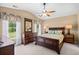 Bedroom with vaulted ceiling, fan, carpet, and natural light from surrounding windows at 4554 Fringetree Dr., Murrells Inlet, SC 29576