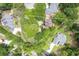 Aerial view of a home surrounded by lush greenery, showcasing its spacious lot at 469 White Heron Ct. Sw, Sunset Beach, NC 28468