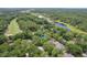Aerial view of a home nestled among trees near a golf course and a lake at 469 White Heron Ct. Sw, Sunset Beach, NC 28468