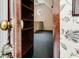 An attic room with a patterned wall and a view into another room with a round window at 469 White Heron Ct. Sw, Sunset Beach, NC 28468