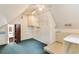 Angle view of finished attic with shelves, storage, unique round window, and ceiling fan at 469 White Heron Ct. Sw, Sunset Beach, NC 28468