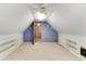Attic room with slanted ceilings, built-in shelves, ceiling fan, and doorway to another room at 469 White Heron Ct. Sw, Sunset Beach, NC 28468
